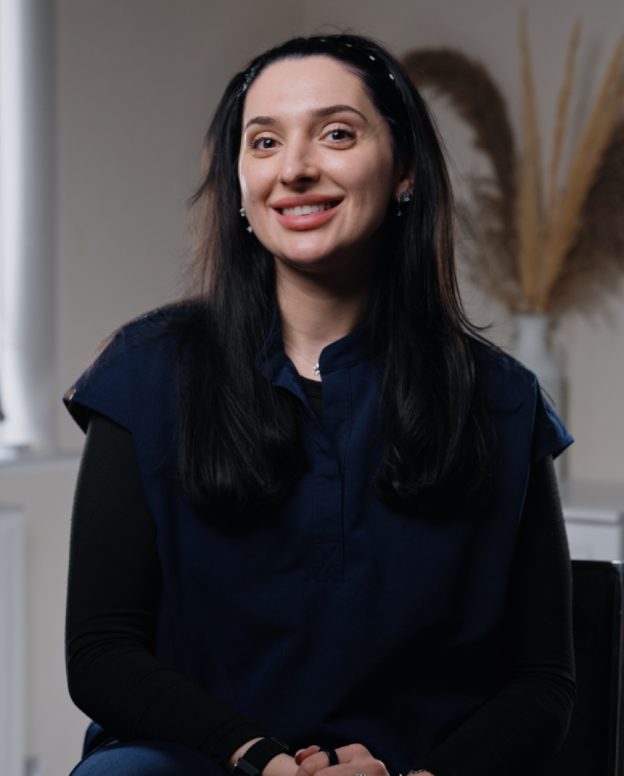 Cristina, Head of Front of House at Sale Dental Spa, smiling at reception — ensuring every patient enjoys a warm, seamless experience at the leading cosmetic dental practice in Sale, South Manchester.