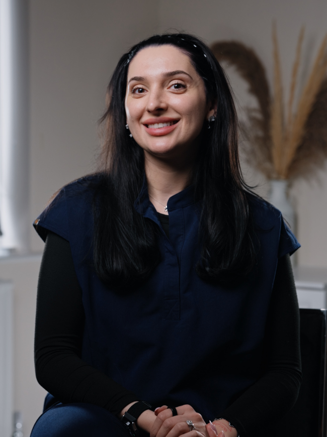 Cristina, Head of Front of House at Sale Dental Spa, smiling at reception — ensuring every patient enjoys a warm, seamless experience at the leading cosmetic dental practice in Sale, South Manchester.