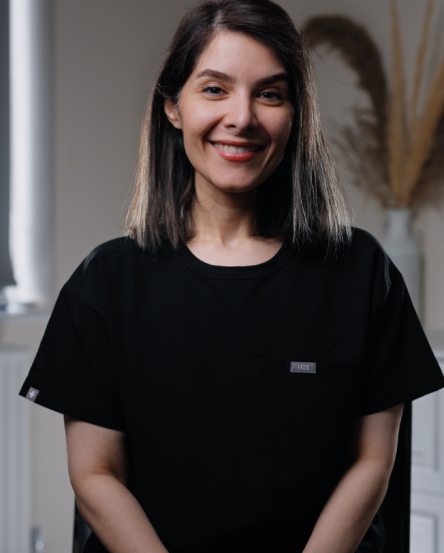 Yalda, Dental Therapist at Sale Dental Spa, smiling in the practice — providing hygiene treatments, preventive care, and professional teeth whitening in Sale, South Manchester.