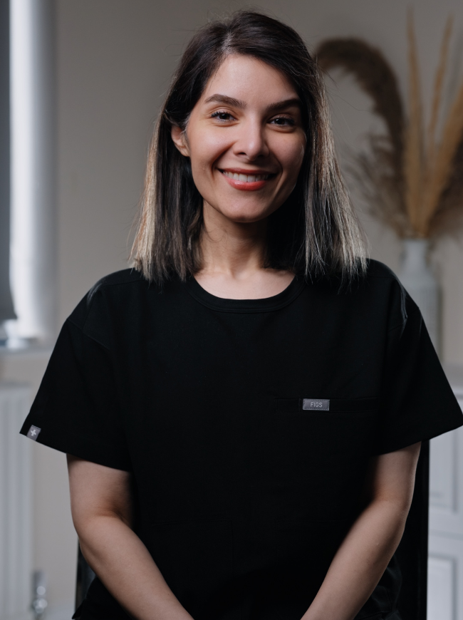 Yalda, Dental Therapist at Sale Dental Spa, smiling in the practice — providing hygiene treatments, preventive care, and professional teeth whitening in Sale, South Manchester.