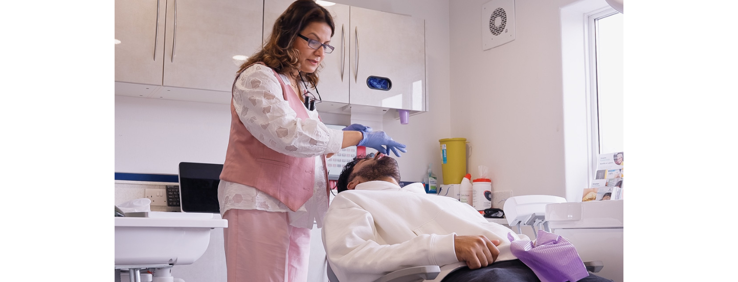 New Patient Dental Exam Dentist performing comprehensive new patient dental exam with 3D scanning technology in Sale, Cheshire