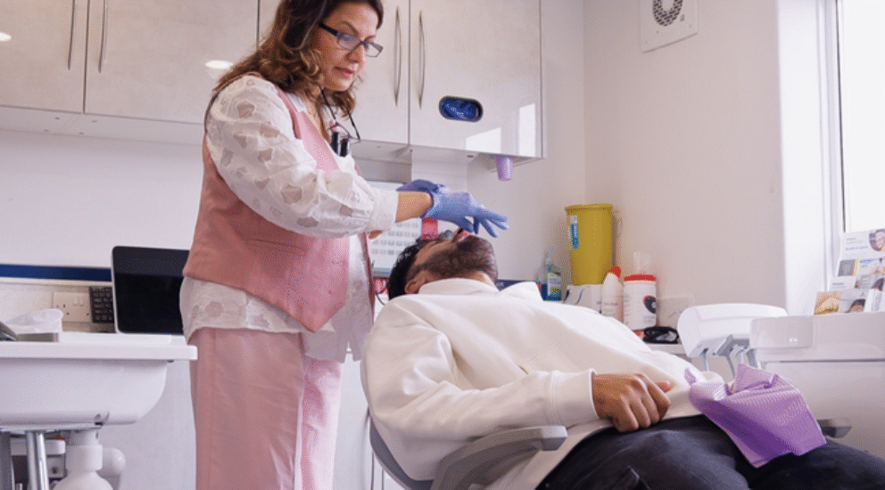 Dentist performing comprehensive new patient dental exam with 3D scanning technology in Sale, Cheshire