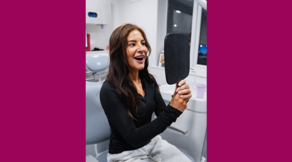 Woman smiling after composite bonding treatment at a cosmetic dental practice in Sale, South Manchester